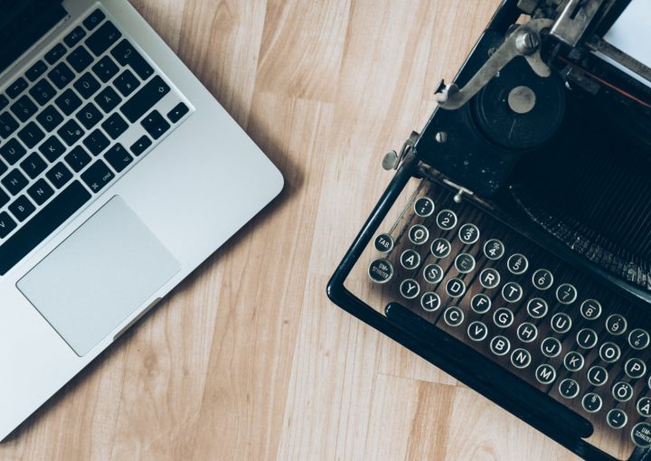 MacBook beside typewriter machine
