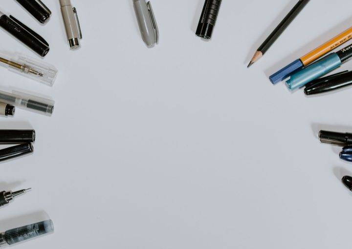 assorted pens on white surface