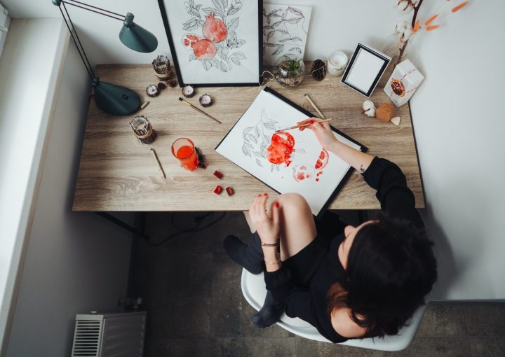 Young woman painting with watercolor paints